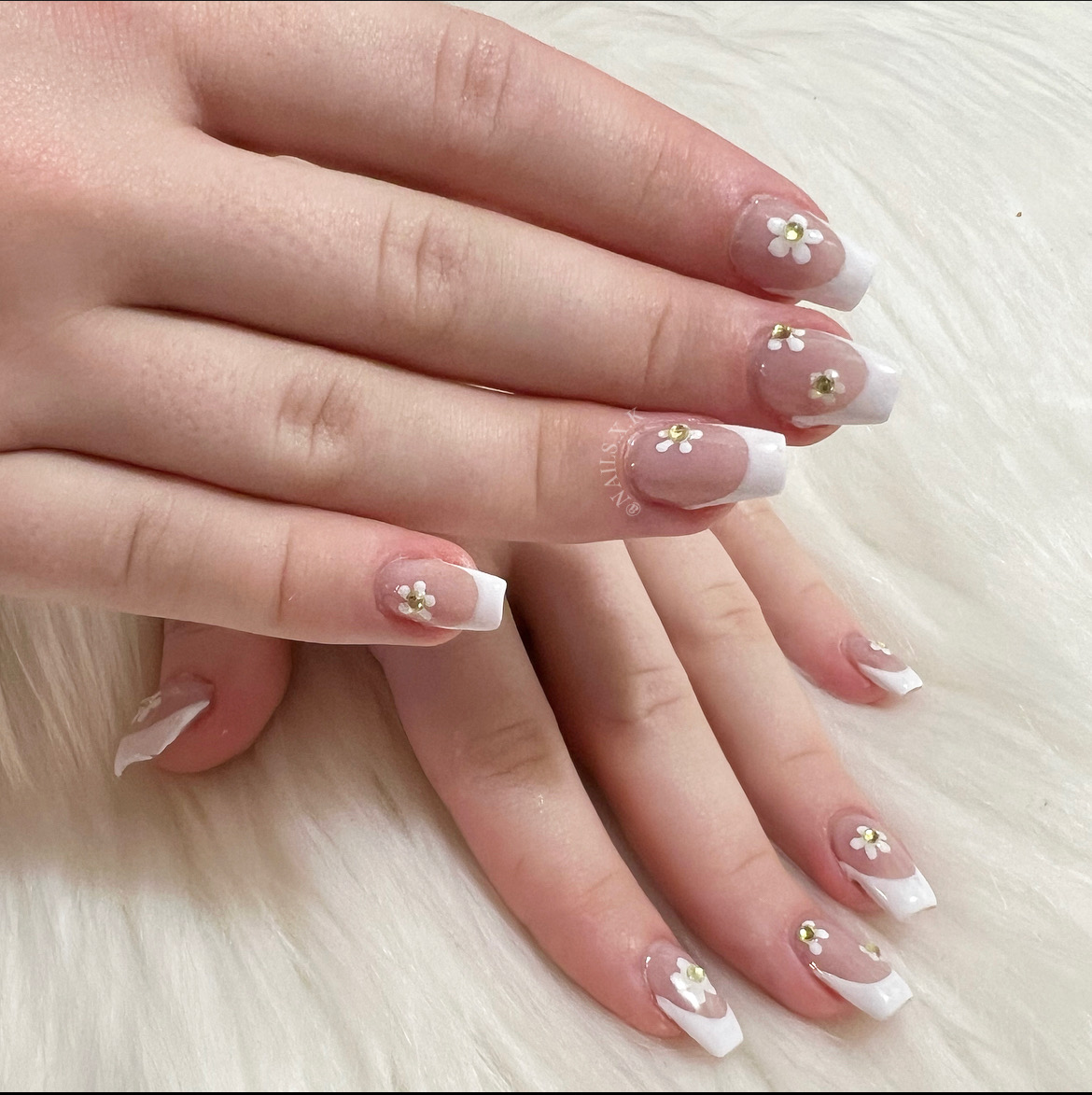 Hard gel set with french tips and floral accents. Nails by K