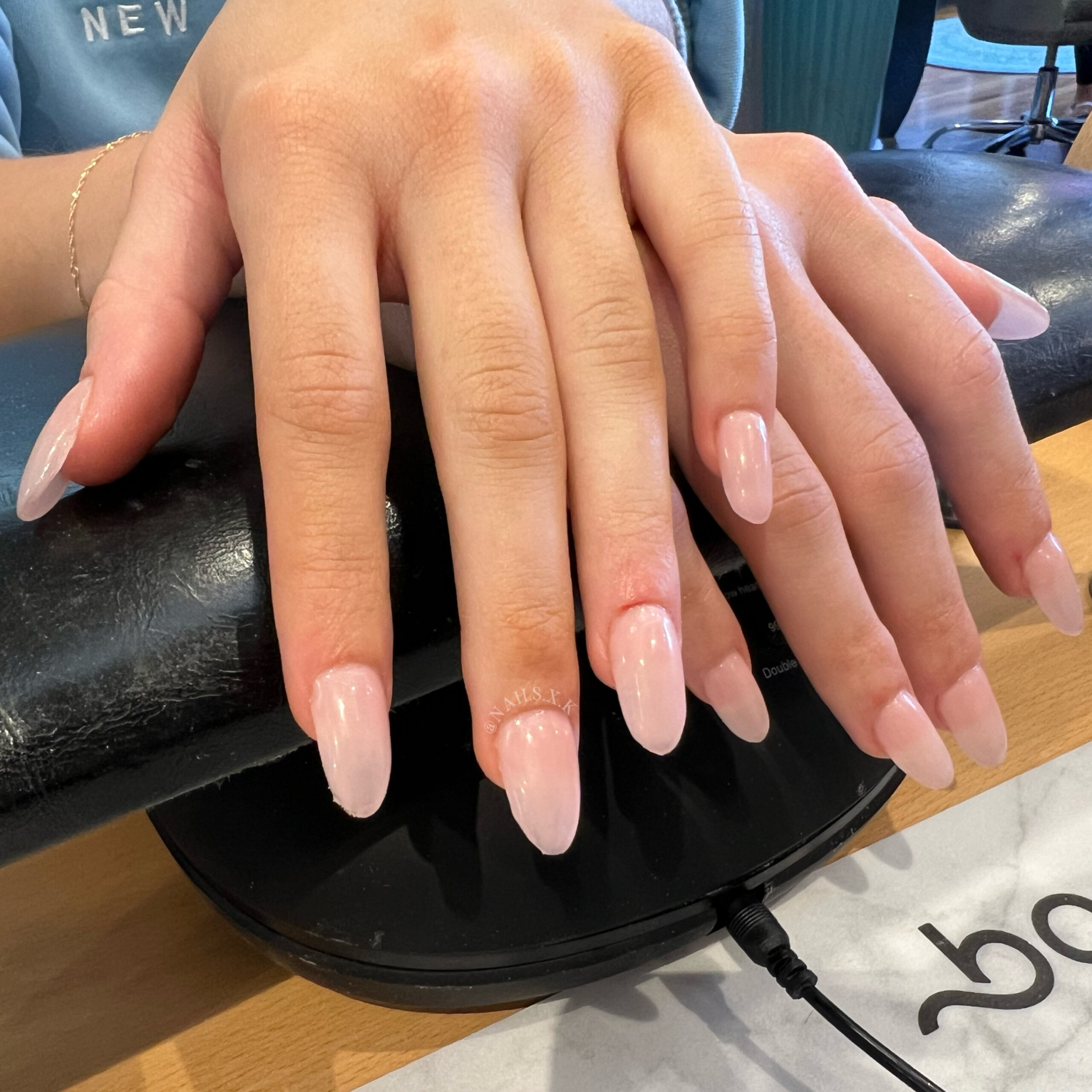 Medium length acrylic sete with a sheer pink color. Nails by K