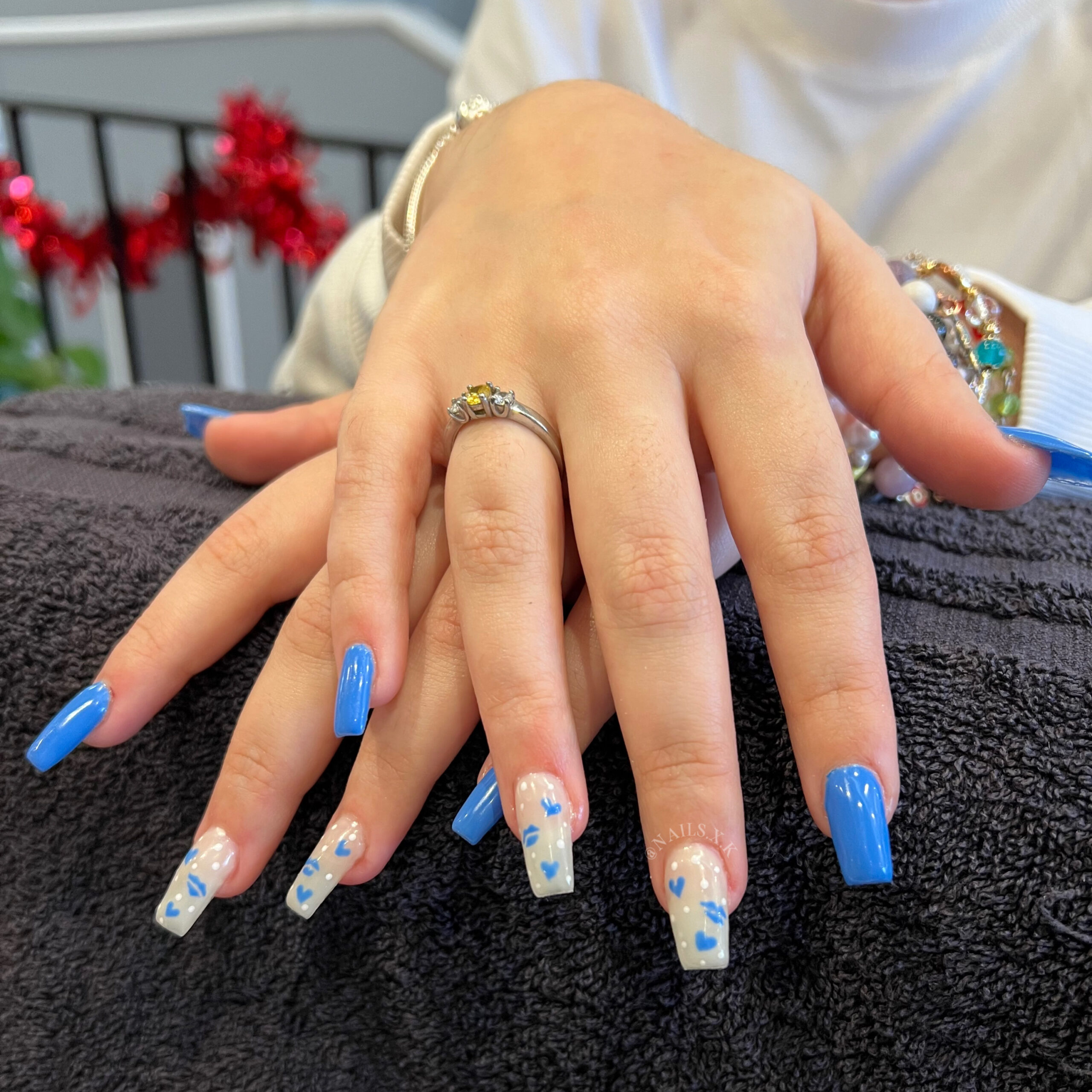 Hard gel full set with bright blue and hand painted hearts and lips. Nails by K