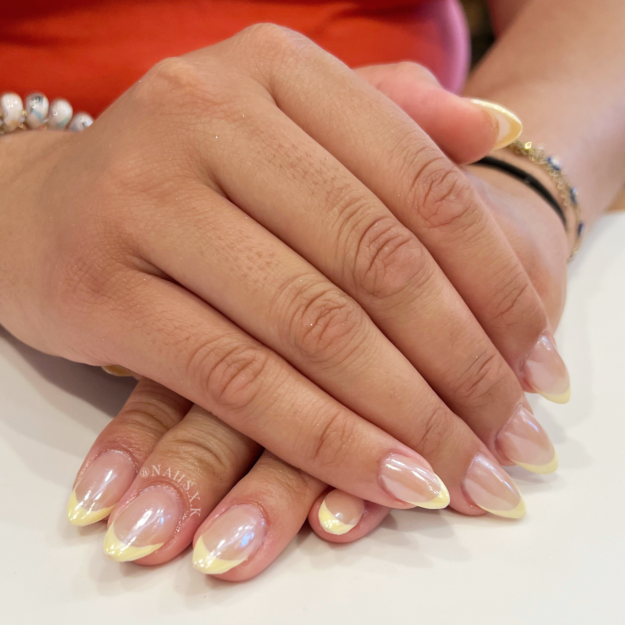 Hard gel fill with light yellow french tips and a pearl chrome on top. Nails by K