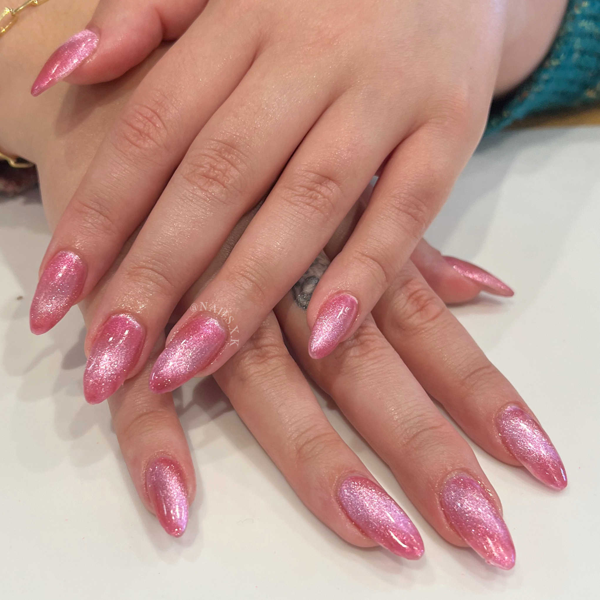 Acrylic fill with a bright pink cat eye. Nails by K