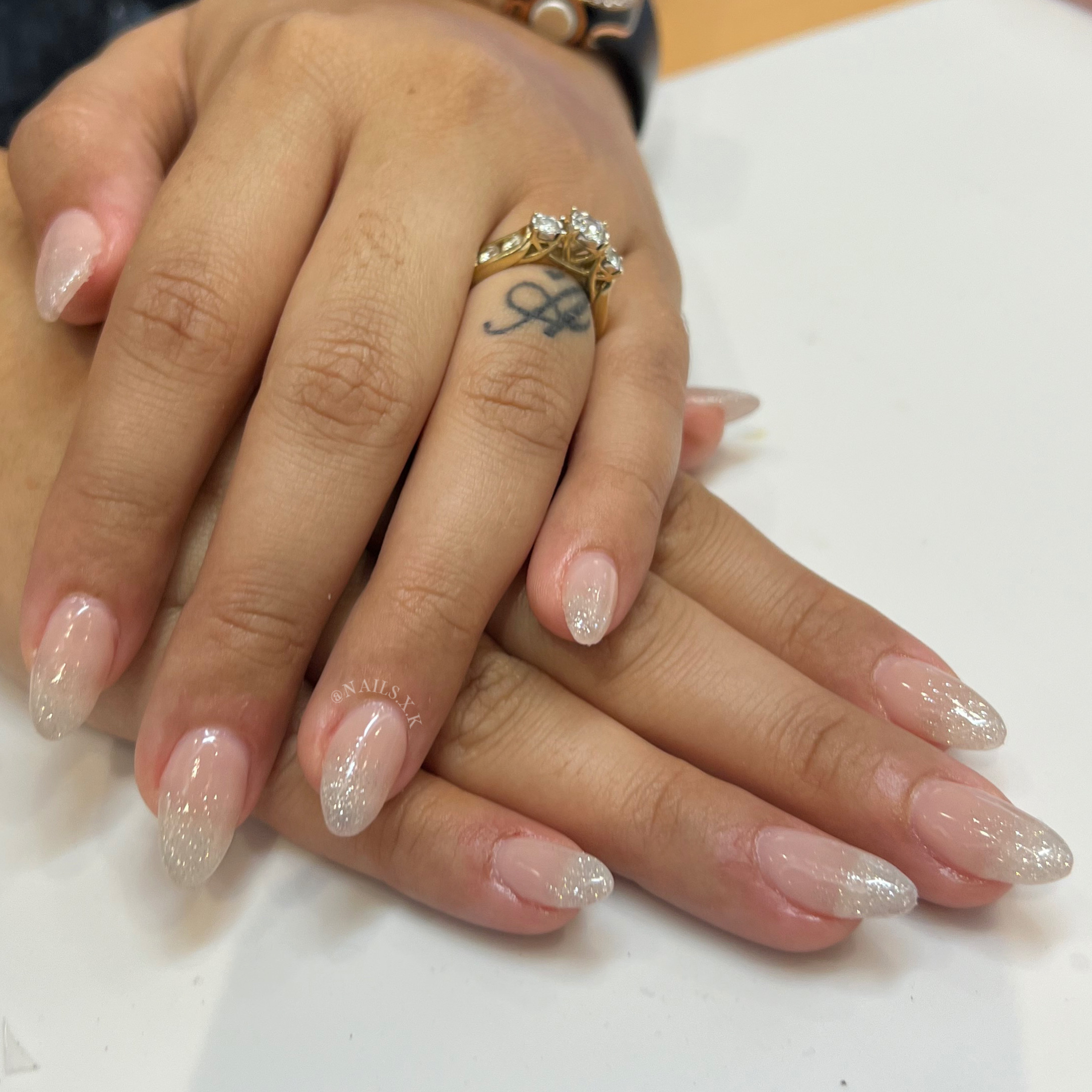 Acrylic nails with a nude base and glitter ombre. Nails by K