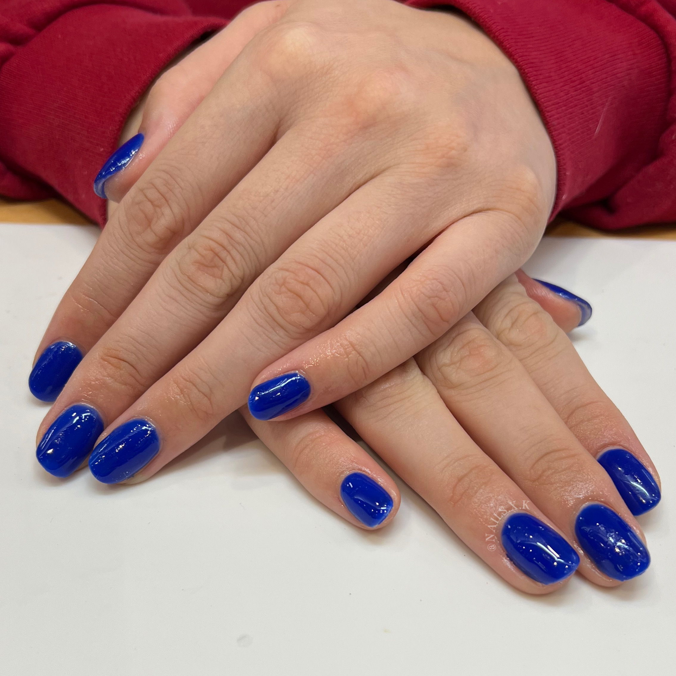 Acrylic nails with a bright blue hue. Nails by K