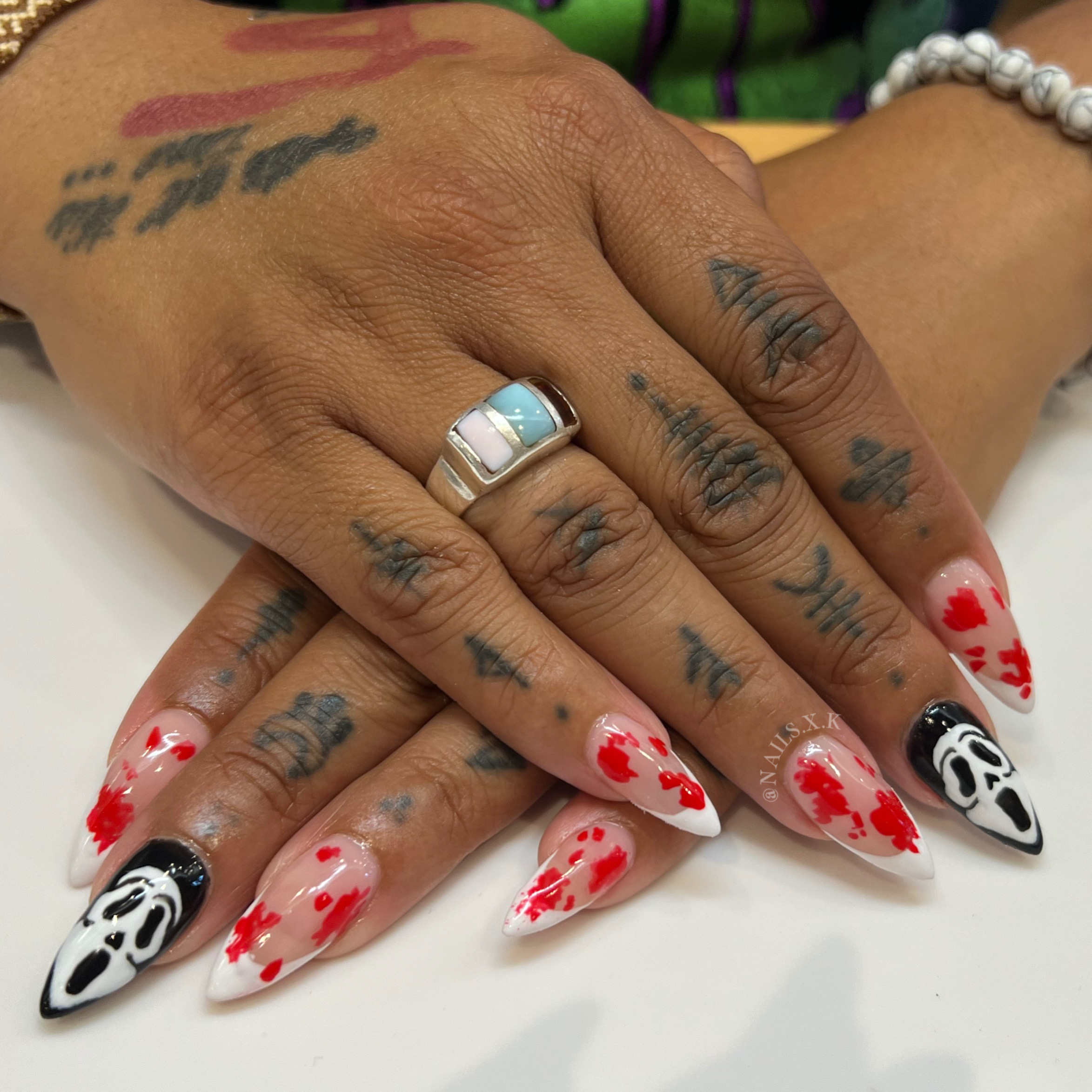 Acrylic nails with french tips and blood splatter along with ghost face art. Nails by K