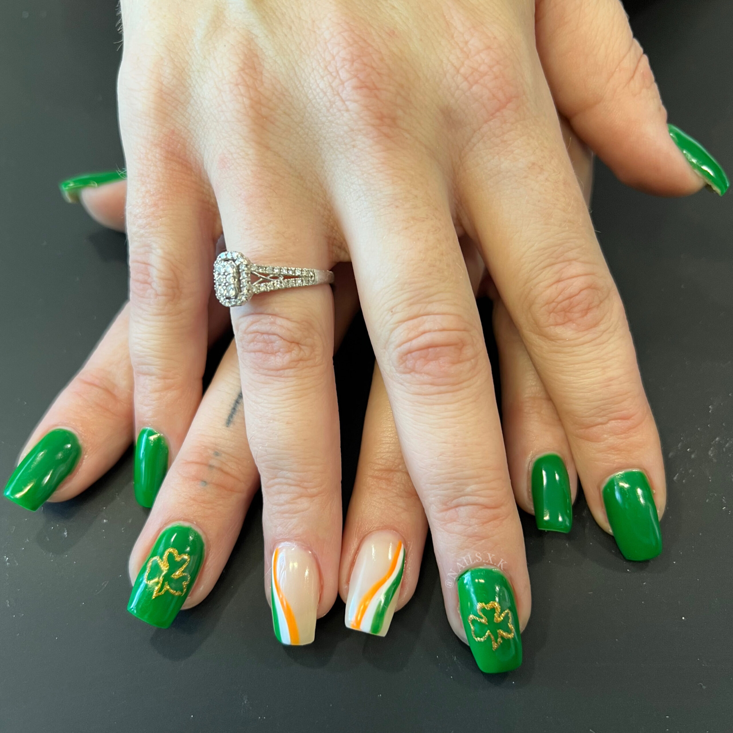 Hard gel nails with hand painted gold clovers. Nails by K