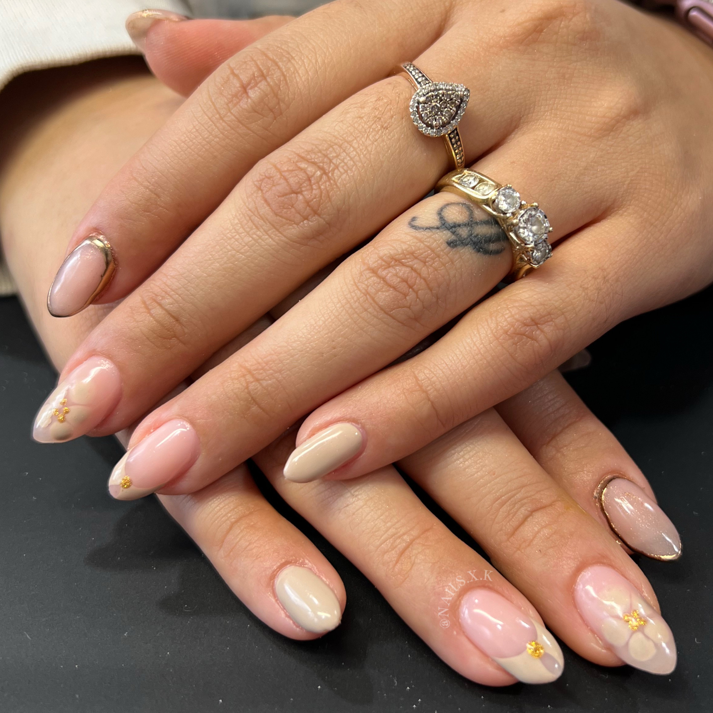 Structured gel manicure with beige nail art and gold accents. Nails by K